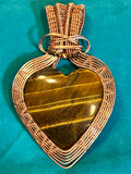 Copper wire wrapped tiger's eye heart pendant approximately 3 inches long