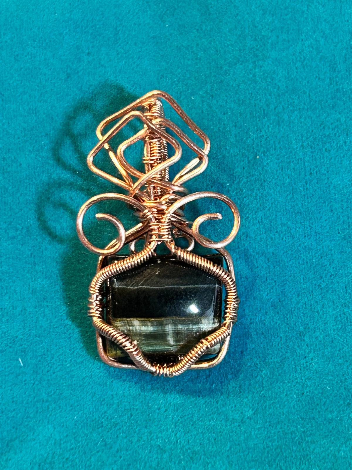 Copper wire wrapped blue tiger's eye pendant approximately 1.25 inches with geometric wire frame