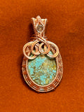Copper basketweave wire wrapped Hubei Turquoise pendant with apatite accent on rust background