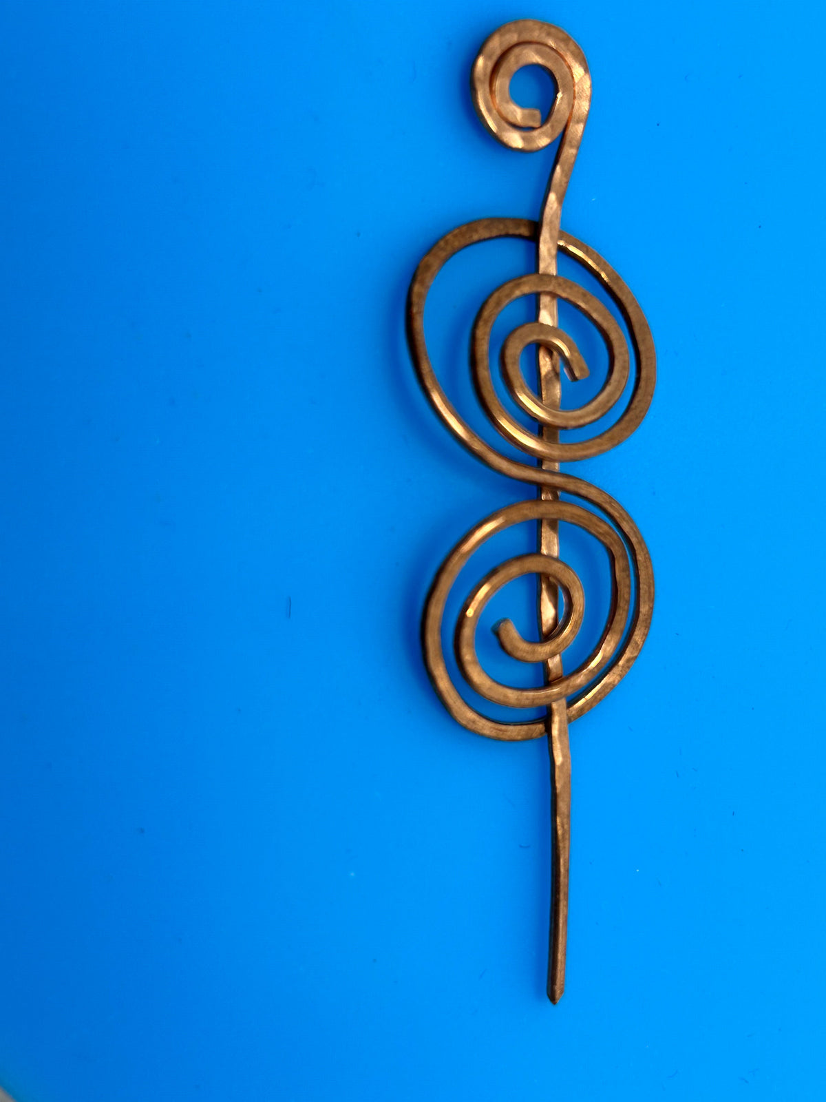 Hammered copper double spiral hair pin approximately 2.5 inches with tapered pin