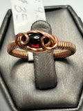 Copper wire wrapped garnet oval cabochon ring size 9.5 with double loop scroll setting