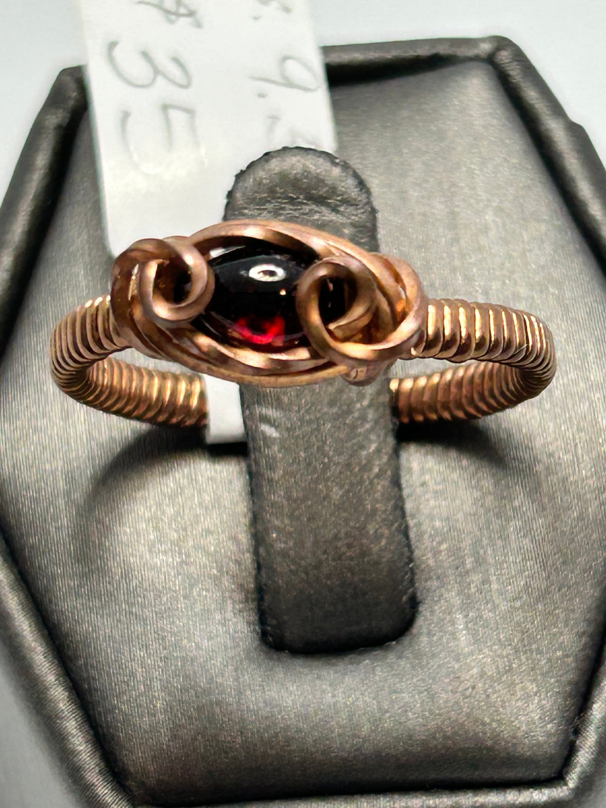 Copper wire wrapped garnet oval cabochon ring size 9.5 with double loop scroll setting