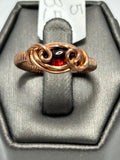 Copper wire wrapped garnet oval cabochon ring size 5 with infinity loop frame and scroll curl accents