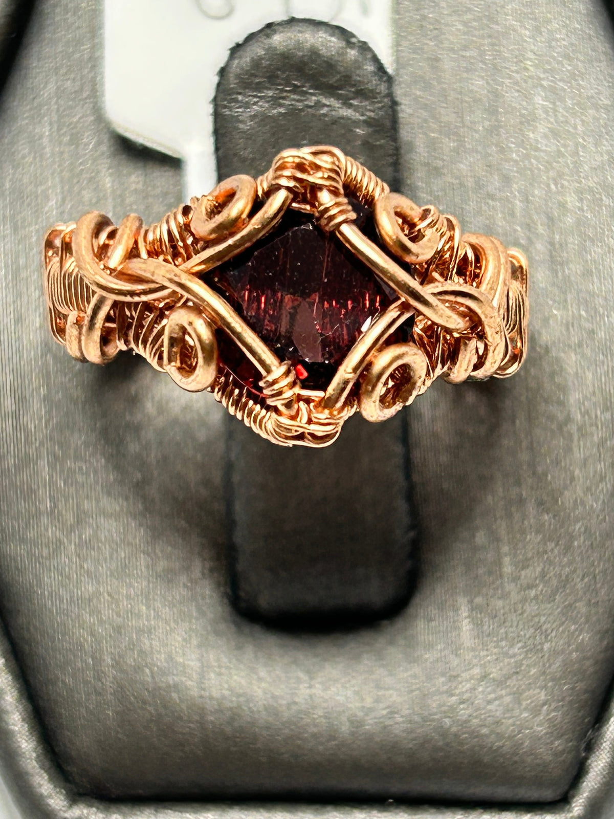 Copper wire wrapped garnet round cabochon ring size 4.5 with diamond frame cross setting and scroll curl cluster accents on wide woven band