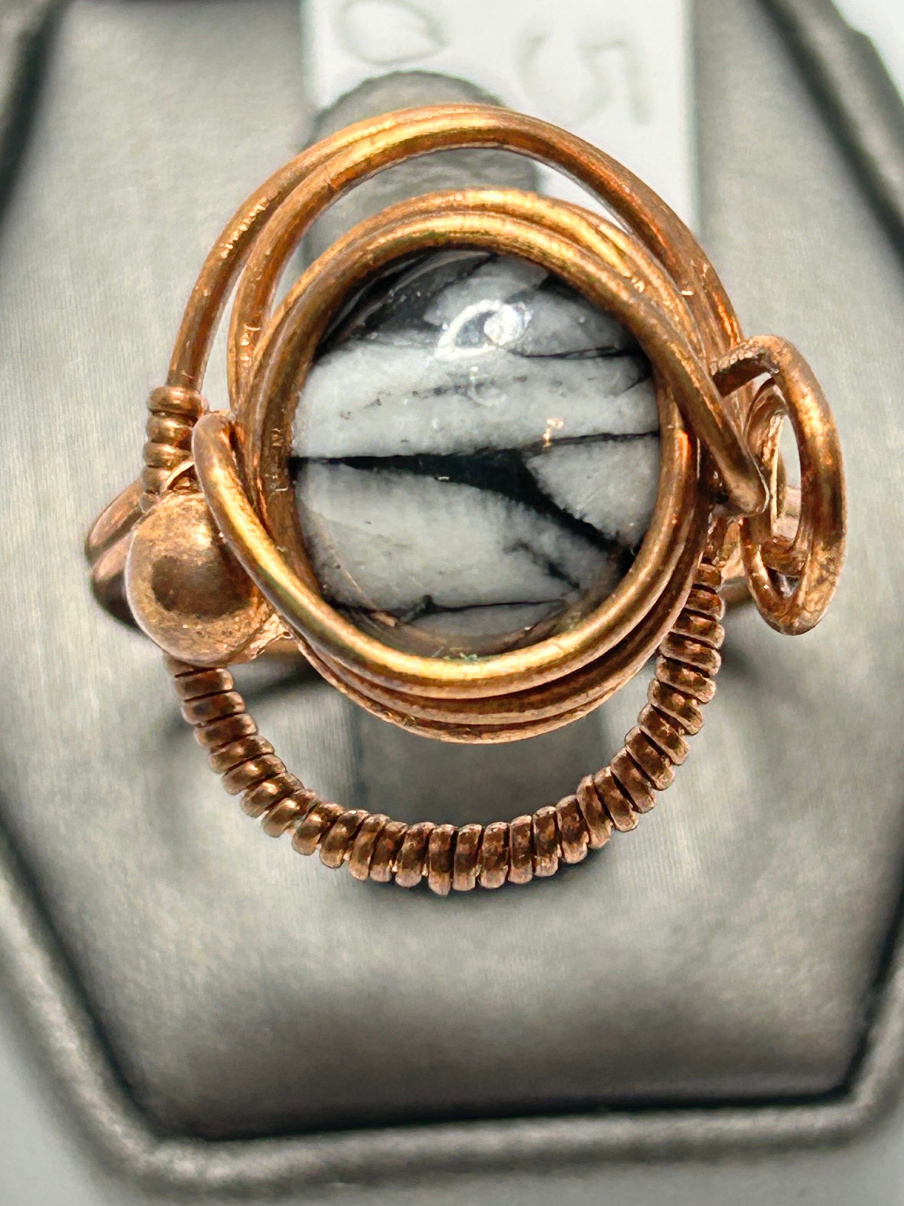 Copper wire wrapped Austrian pinolith oval cabochon ring size 9.5 with orbital arch wire setting and bead and loop side accents