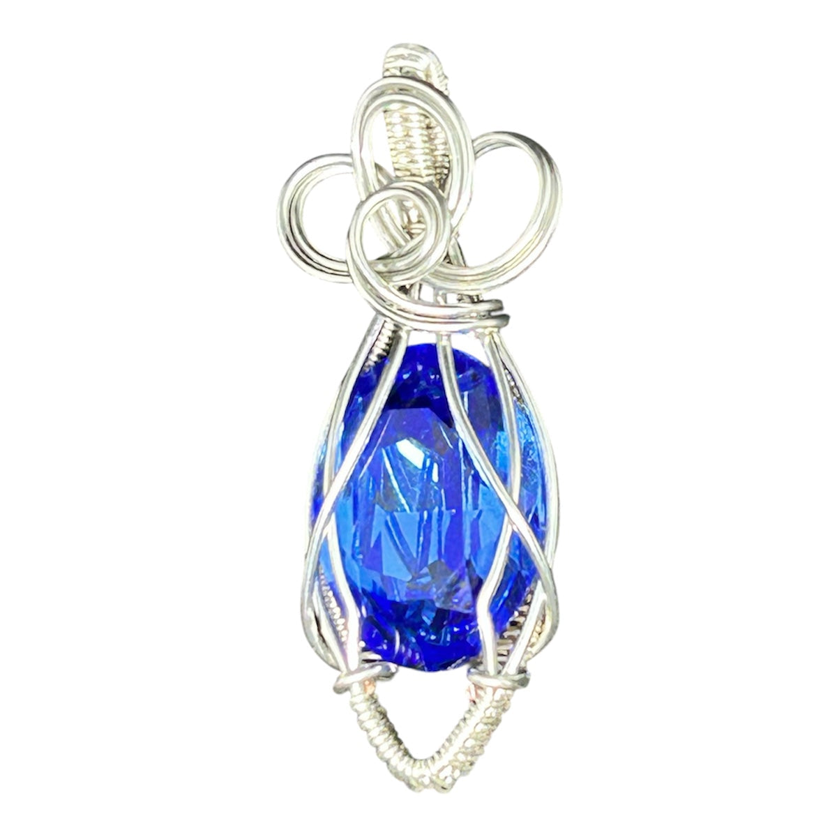 Silver wire wrapped sapphire blue Swarovski crystal pendant with triple-loop bow bail on white background
