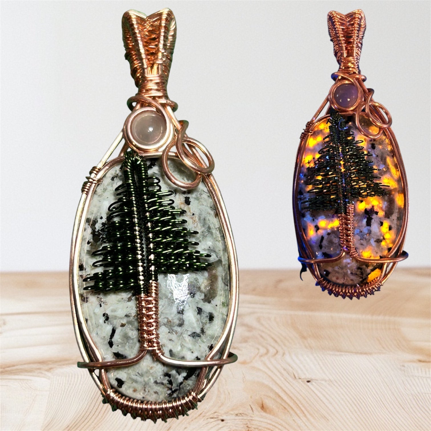 Copper wire wrapped Yooperlight pendant with black wire pine tree and moonstone accent, shown with UV glow effect