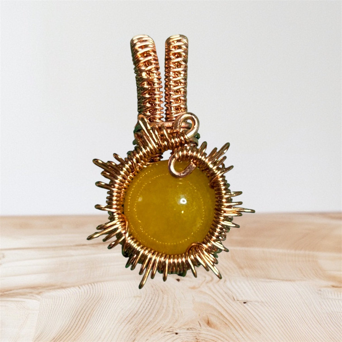 Copper wire wrapped yellow jade sunburst pendant with radiating wire rays and dual coiled copper tube bail, handcrafted by KariJKrafts